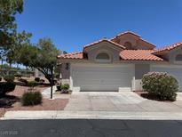Charming one-story home with a two-car garage, a terra cotta roof, and well-maintained landscaping at 7830 Foxwood Pl # 7830, Las Vegas, NV 89145
