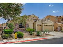 Charming single-story home featuring stone accents, a two-car garage, and a well-maintained desert landscape at 83 Buckthorn Ridge Ct, Las Vegas, NV 89183