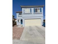Two-story home with blue shutters and a two-car garage on a sunny day at 8484 Montana Stream Ave, Las Vegas, NV 89113