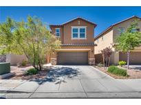 Two-story home featuring a well-manicured lawn, covered porch and a two-car garage at 889 Harbor Ave, Henderson, NV 89002