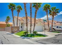 Charming two-story home featuring a well-manicured lawn and tall palm trees against a clear blue sky at 8953 Paige Rene Ct, Las Vegas, NV 89117