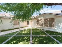 Charming single-story home with a well-maintained front yard and lovely artificial grass at 1723 Candice St, Las Vegas, NV 89156