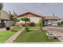 Charming single-story home with a brick and stucco exterior and tidy front yard at 2112 Los Altos St, Las Vegas, NV 89102