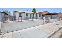 Charming single-story home featuring a block wall and decorative iron fencing for added curb appeal and security at 2313 Van Patten Pl, Las Vegas, NV 89104