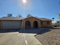 Charming single-story home with arched entry, gravel landscaping, and attached two-car garage at 256 Winona Ter, Henderson, NV 89015