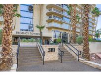 Elegant entrance to Regency Towers with well-manicured landscaping and prominent building signage at 3111 Bel Air Dr # 201, Las Vegas, NV 89109