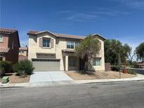 Two-story home featuring a two-car garage and drought tolerant landscaping at 3941 Copper Stone Ct, North Las Vegas, NV 89032