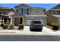 Charming two-story home featuring a two-car garage and manicured front yard at 5824 Gemstone Peak St, North Las Vegas, NV 89031