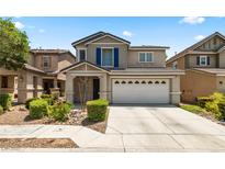 Charming two-story home featuring a well-maintained front yard and attached two car garage in a suburban community at 5824 Gemstone Peak St, North Las Vegas, NV 89031