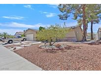 Inviting front yard with mature landscaping and a well-maintained exterior at 7113 Carrondale Way, Las Vegas, NV 89128