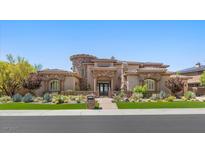 Elegant single-Gathering home showcasing lush landscaping and a circular stone accent at 73 Kittansett Loop, Henderson, NV 89052