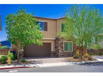Charming two-story home features a two-car garage, stone accents, and a well-manicured front yard at 7733 Harthill Park Ave, Las Vegas, NV 89113