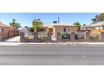 Charming single-story home featuring a secure brick and iron fence and well-maintained exterior at 805 E Carey Ave, North Las Vegas, NV 89030