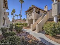 Attractive two-story condo building with stairs, stucco siding and desert landscaping at 1409 Santa Margarita St # G, Las Vegas, NV 89146