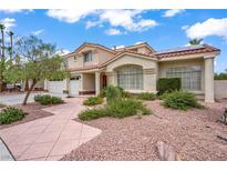 Inviting two-story home with a three-car garage, desert landscaping and stylish architectural details at 2010 Catalina Marie Ave, Henderson, NV 89074
