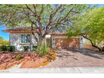 Charming single-story home with a well-manicured front yard and a brick driveway at 2154 Idaho Falls Dr, Henderson, NV 89044