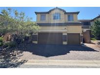 Charming two-story home features a two-car garage and desert landscaping, enhancing curb appeal at 252 Quail Ranch Dr, Henderson, NV 89015