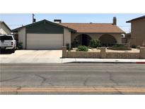 Charming single-story home featuring a two-car garage and a quaint front yard, perfect for curb appeal at 308 Sunbeam Dr, Las Vegas, NV 89107
