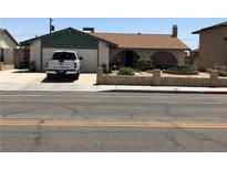 Charming single story home featuring a front yard with mature landscaping and an attached two-car garage at 308 Sunbeam Dr, Las Vegas, NV 89107