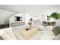 Bright, open-concept living room featuring modern decor and seamless flow to the kitchen at 3240 Avernus Ave, Henderson, NV 89044