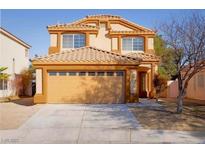 Charming tan two-story home featuring a two-car garage and well-maintained landscaping at 3412 Adventure Ct, Las Vegas, NV 89129