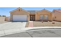 Inviting single-story home with neutral stucco, tiled roof, desert landscaping, and a convenient two-car garage at 3538 Canter Dr, North Las Vegas, NV 89032