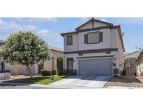 Charming two-story home with a well-manicured lawn and mature flowering tree at 4435 Peaceful Harbor St, Las Vegas, NV 89129
