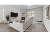 Bright living room features modern furnishings, fireplace, and large window for ample natural light at 4730 E Craig Rd # 1093, Las Vegas, NV 89115