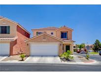 Inviting two-story home featuring a well-manicured front yard, an attached garage, and a charming facade at 5516 Tantalum Ln, Las Vegas, NV 89122