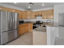 Bright kitchen features granite countertops and stainless steel appliances at 575 Aspen Leaf St, Las Vegas, NV 89144