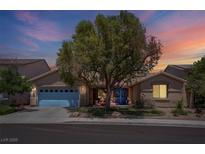 Charming single-story home with mature tree, blue garage door, and beautiful sunset sky at 5896 Shining Moon Ct, Las Vegas, NV 89131