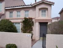 Charming two-story townhome featuring a front door and manicured landscaping at 59 Belle Maison Ave, Las Vegas, NV 89123