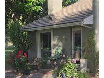 Charming front porch with chairs and lovely roses in a beautiful yard setting at 632 at 632 Tam O Shanter, Las Vegas, NV 89109
