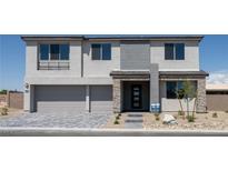 Stunning two-story home with modern design, two-car garage, and stone accents creating a welcoming curb appeal at 7199 Twilight Rider Ct, Las Vegas, NV 89118