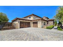Stunning two-story home featuring a tile roof, stucco walls, stone accents, and an inviting three-car garage at 8010 Palm Cove Ct, Las Vegas, NV 89129