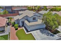 Charming two-story home with a well-manicured lawn and a spacious two-car garage at 975 Leadville Meadows Dr, Henderson, NV 89052