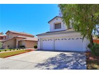 Charming two-story home with a well-manicured lawn and a spacious driveway leading to a two-car garage at 975 Leadville Meadows Dr, Henderson, NV 89052