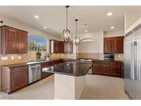 Spacious kitchen with stainless steel appliances, granite countertops, and custom cabinetry at 9853 Russian Hill St, Las Vegas, NV 89141