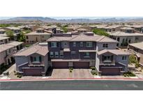 Modern townhome showcases a unique purple exterior, complemented by a tile roof and multiple garage spaces at 10013 Sable Point St, Las Vegas, NV 89178