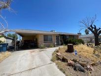 Single story home with covered parking and front yard landscape at 225 Elm St, Henderson, NV 89015