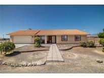Charming single-story home with well-maintained landscaping and a tile roof at 2730 Banyon St, Pahrump, NV 89048