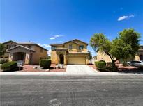 Charming two-story home featuring a well-manicured lawn, desert landscaping, and attached two car garage at 3412 Catherine Mermet Ave, North Las Vegas, NV 89081