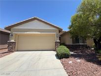 Charming single-story home featuring a two-car garage, desert landscaping, and mature shade tree at 3720 Tack St, Las Vegas, NV 89122