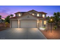 Charming two-story home with a red tile roof, three-car garage, and desert landscaping at 4021 Mountain Trek St, Las Vegas, NV 89129