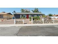 Charming single-story home with brick driveway, stone accents, and vibrant front yard landscaping at 4027 Maple Hill Rd, Las Vegas, NV 89115