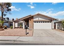 Charming single-story home featuring a two-car garage, desert landscaping and neutral color palette at 4775 Woodridge Rd, Las Vegas, NV 89121