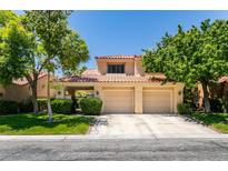 Charming home featuring a terra cotta tile roof, an attached two-car garage and well-manicured front lawn at 5133 Southern Hills Ln, Las Vegas, NV 89113