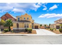 Charming two-story home with a well-maintained front yard and long driveway at 5938 Village Loft St, North Las Vegas, NV 89081