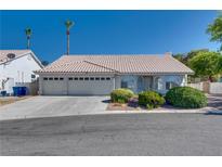 Charming single-story home featuring a three-car garage and desert landscaping at 825 Royal Moon Ave, Las Vegas, NV 89123