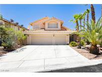Charming two-story home with a two-car garage, desert landscaping, and a tile roof at 8875 Tidal Bay Dr, Las Vegas, NV 89117